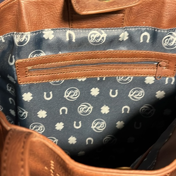 Lucky Brand brown studded purse with cutouts and Teal & horseshoe print lining. - Picture 7 of 8